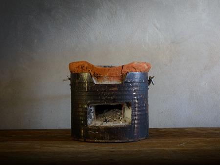 Antique charcoal stove on wooden floorの写真素材
