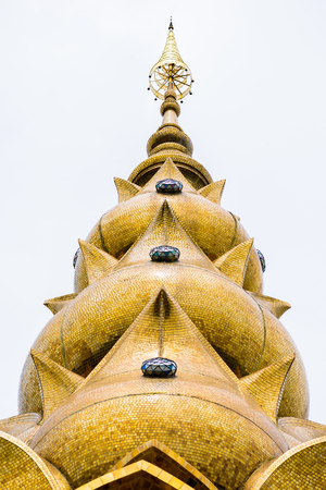 architecture of Wat Phra That Pha Son Kaew, PETCHRABOON province, THAILAND. buddhism crafts religions handwork on glass and ceramic tiles decoration on gold color pagoda surfaceの写真素材