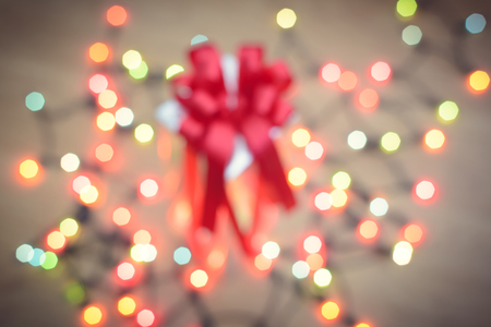 Christmas gift boxes with decorative light on woodの写真素材