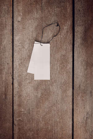 white price tag label on wooden background