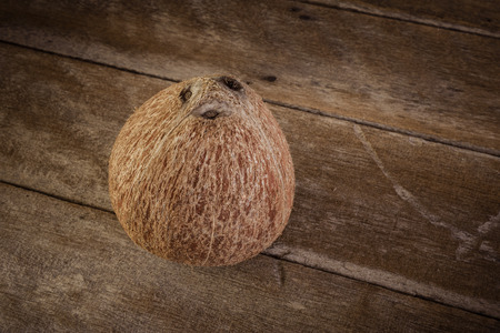 fresh coconuts on old wooden tableの写真素材