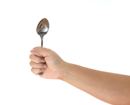 Male hand holding an empty spoon, composition isolated over on the white backgroundの写真素材