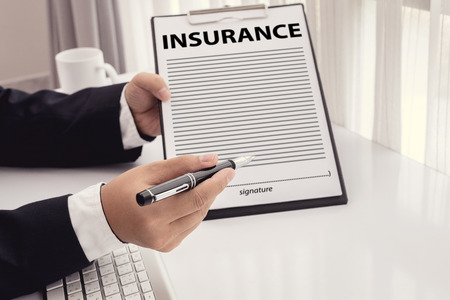 Staff recommended the benefits of insurance coverage and invite customers to sign a contractの写真素材