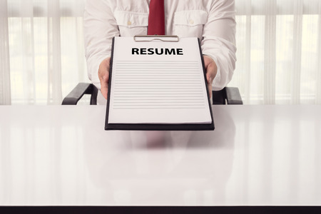 Young businessman giving a resume in office. applying for a job conceptの写真素材