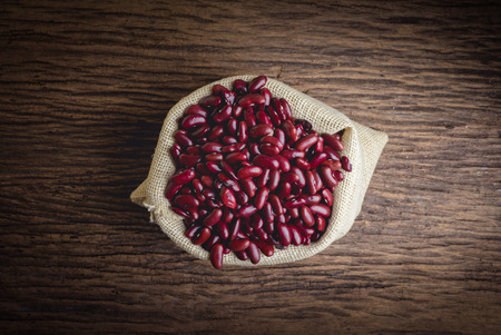 Kidney bean,Red beans in sack on wood tableの写真素材