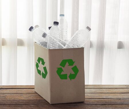 Recycling Cardboard box filled with clear plastic containersの写真素材