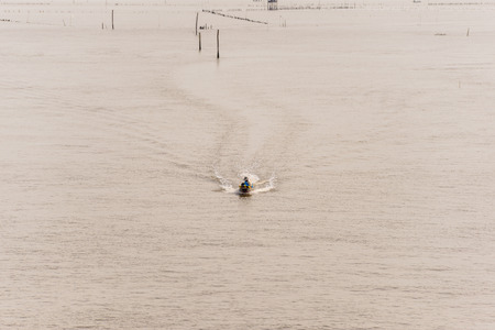 Life asian fisherman and fishing boat Sailing in the sea at Bang Taboon, Phetchaburi, Thailandの写真素材