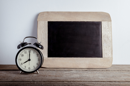 Alarm clock and chalk boad empty for your text. Back to school concept with copy spaceの写真素材