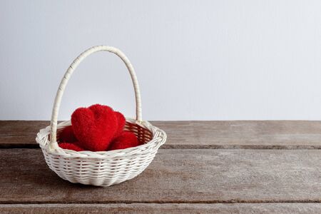 hearts in wicker basket, on rustic wooden backgroundの写真素材