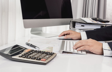 Business man working at office with desktop computer and documents on his desk, consultant lawyer...