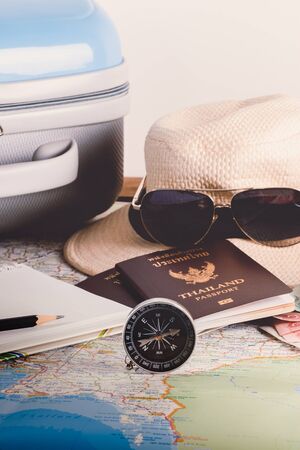 Save money for travel trip. Travel accessories for the travel trip. Passports, luggage, compass, Camera,  notebook, pencil The cost of travel maps prepared for the adventure travel tripの写真素材
