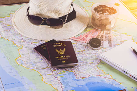 Save money for travel trip. Travel accessories for the travel trip. Passports, compass, notebook, pencil The cost of travel maps prepared for the adventure travel tripの写真素材