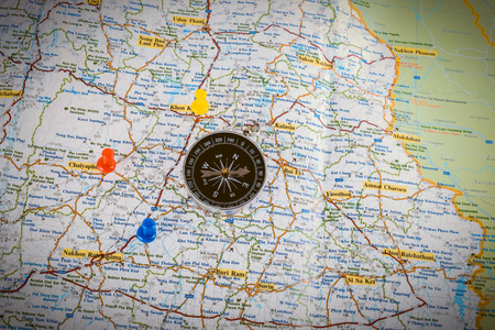 Closeup Compass on map with colorful pin
