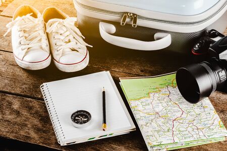 Travel accessories for the travel trip. Passports, luggage, compass, Camera,  notebook, pencil The cost of travel maps prepared for the adventure travel tripの写真素材
