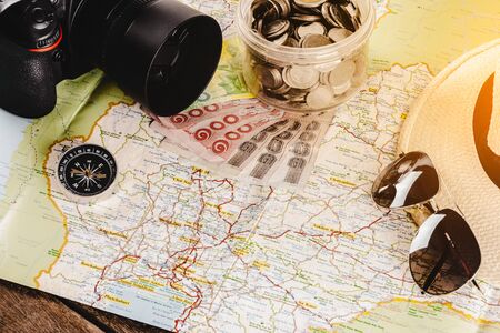 Save money for travel trip. Travel accessories for the travel trip. compass, Camera, hat, sunglasses...