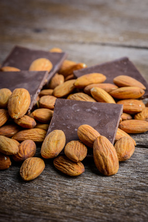 chocolate with almond on wooden backgroundの写真素材