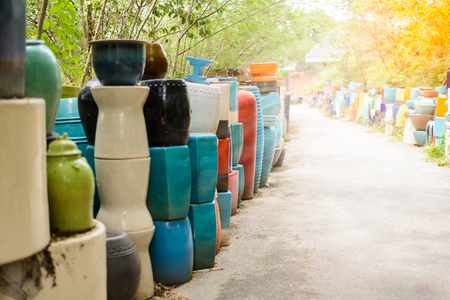 multicolored ceramic bowls, Colorful pots and cups or vases handcrafted. Placement for gardening and walkways arrangementの写真素材