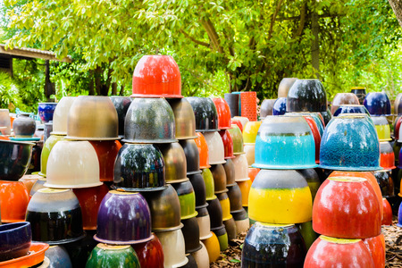 multicolored ceramic bowls, Colorful pots and cups or vases handcrafted. Placement for gardening and walkways arrangementの写真素材