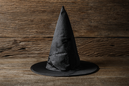 Witch hat on wooden table. Halloween holiday conceptの写真素材