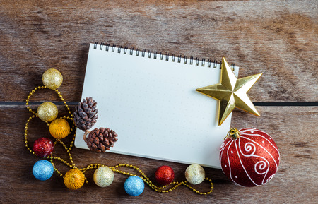 Christmas decoration, ornaments, theme with blank Notebook on wooden planks  backgroundの写真素材