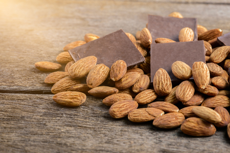 chocolate with almond on wooden backgroundの写真素材