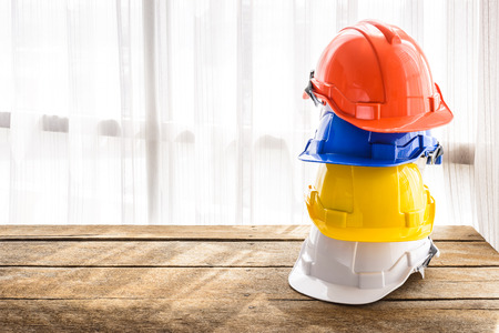 orange, blue, yellow, white hard safety helmet construction hat for safety project of workman as engineer or workerの写真素材