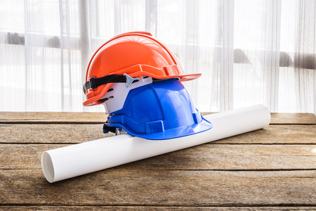 orange, blue hard safety helmet construction hat for safety project of workman as engineer or...