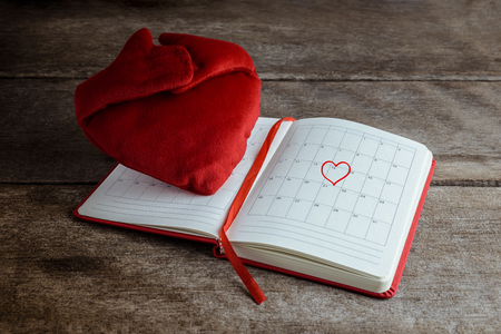 Calendar memo, notebook with the red Heart pillow and Heart shape mark on February 14, Saint Valentines day conceptの写真素材