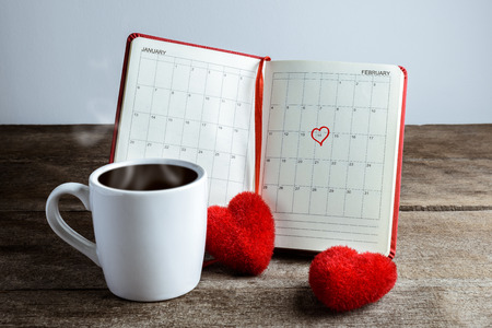 Calendar memo, notebook with the red Heart pillow, coffee cup and Heart shape mark on February 14, Saint Valentines day conceptの写真素材