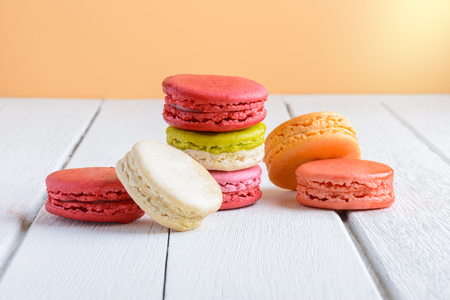 Different types color of macaroons on white wooden background Vintage styleの写真素材