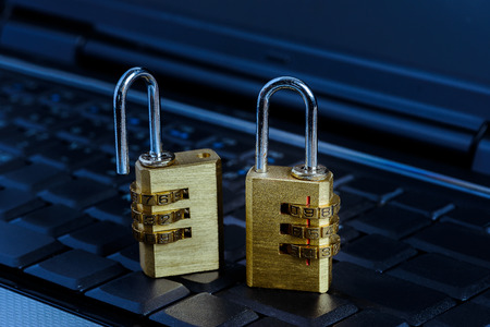 Closeup metal security lock with password on computer keyboard, security double lock concept in...