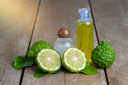 cosmetic products Bergamot essential oil shampoo and Shower Gel from fresh bergamot fruit on wooden tableの写真素材