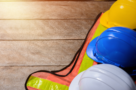 Standard construction safety equipment on old wooden background. top view, safety first concepts