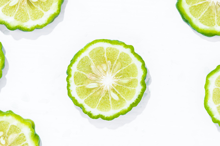 Closeup fresh bergamot fruit slice isolated on white background with clipping pathの写真素材