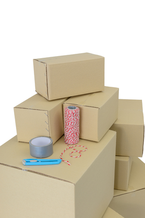 Cardboard boxes in different sizes stacked boxes, Adhesive tape, rope and Cutter isolated on white background with clipping pathの写真素材