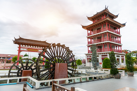 Water wheel and Tower decorated in Chinese style at The Celestial Dragon Village, Suphanburi, Thailandのeditorial素材