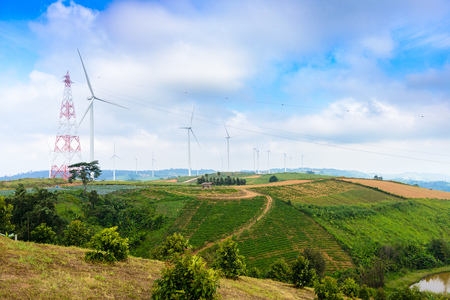 View of turbine on mountain. Windmill turbine field for electric production with blue sky at Khao...