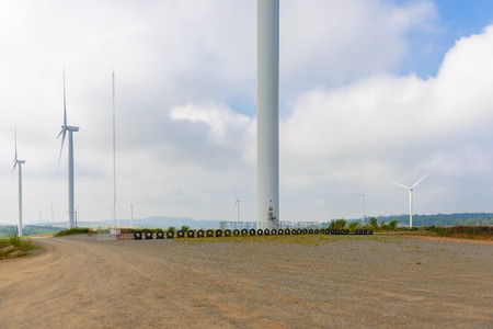 View of turbine on mountain. Windmill turbine field for electric production with blue sky at Khao...