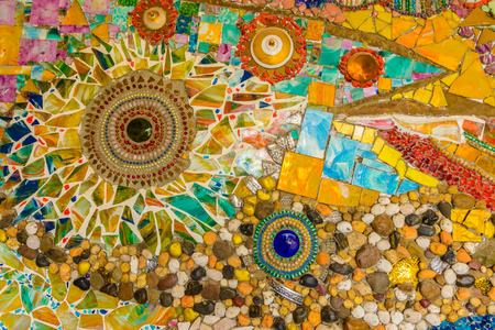 Close up Background of handwork on fancy colorful ceramic decorated the wall of buddhism pagoda in Wat Pha Son Kaew, Petchaboon Thailandの写真素材