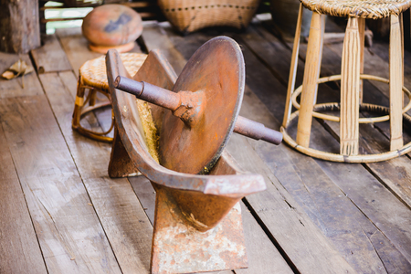 Ancient medicine grinder on wooden floor