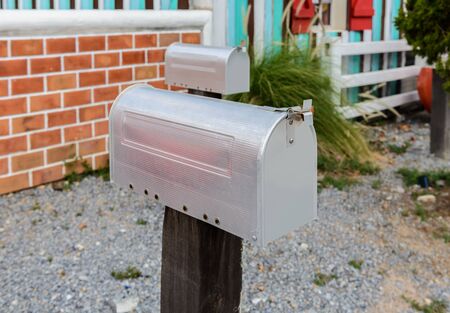 Retro style silver mailbox on wooden posts