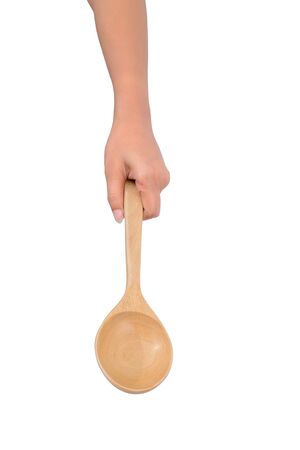 Asian female hands are holding Wooden ladle isolated on white isolated on white background with clipping pathの写真素材
