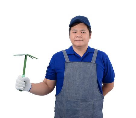 asian worker man in blue shirt with apron and protective gloves hand holding Shoveling fork isolated on white background with clipping pathの写真素材