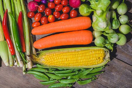 Backgroud group of fresh food tasty and healthy varis vegetables are on the wooden tableの写真素材