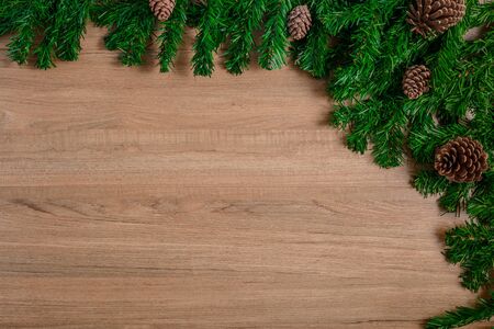 Fir branches and Pine cones on wooden board. Christmas or New year backgroundの写真素材