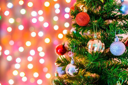 Christmas decoration star and balls Hanging on pine branches christmas tree garland and ornaments with abstract bokeh background with copy spaceの写真素材