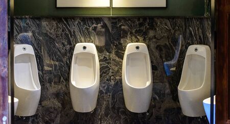 Row of urinal in Empty public men toilet in modern styleの写真素材
