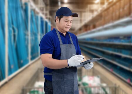 Portrait of male staff warehouse operator with Blurred the background of equipment tool for technician or worker on product shelf in Construction material storeの写真素材