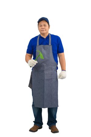 asian worker man in blue shirt with apron and protective gloves hand holding Shoveling fork.の写真素材