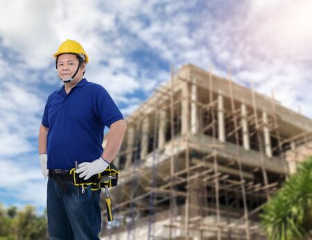 Portrait of Male Construction foreman supervisor or worker with Protection Equipment and blurred background is construction siteの写真素材